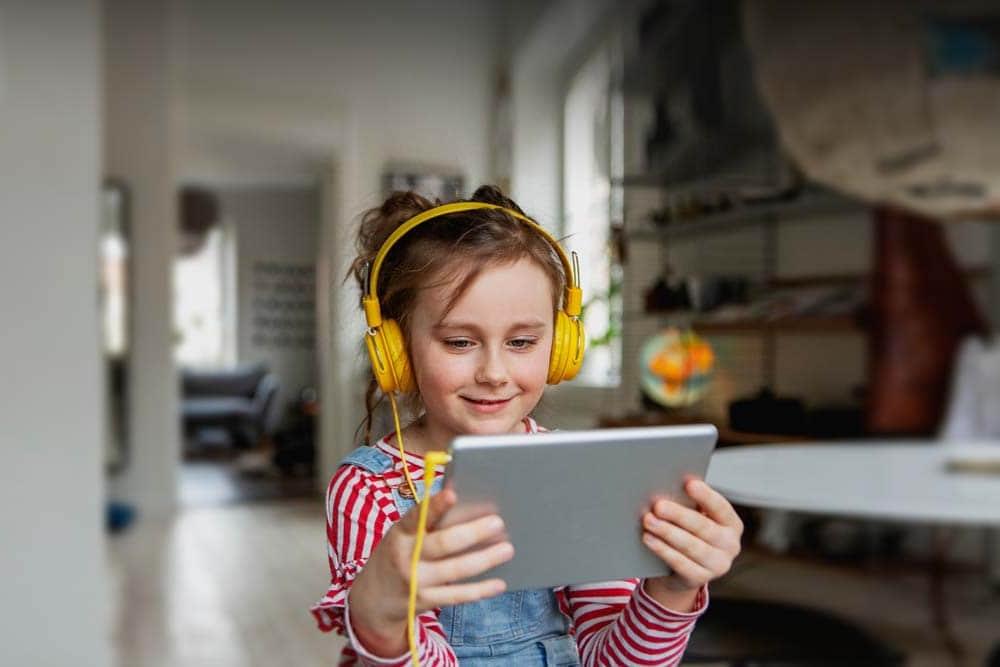 Female student with yellow headphones working on an online class at Oregon's Willamette Connections Academy.